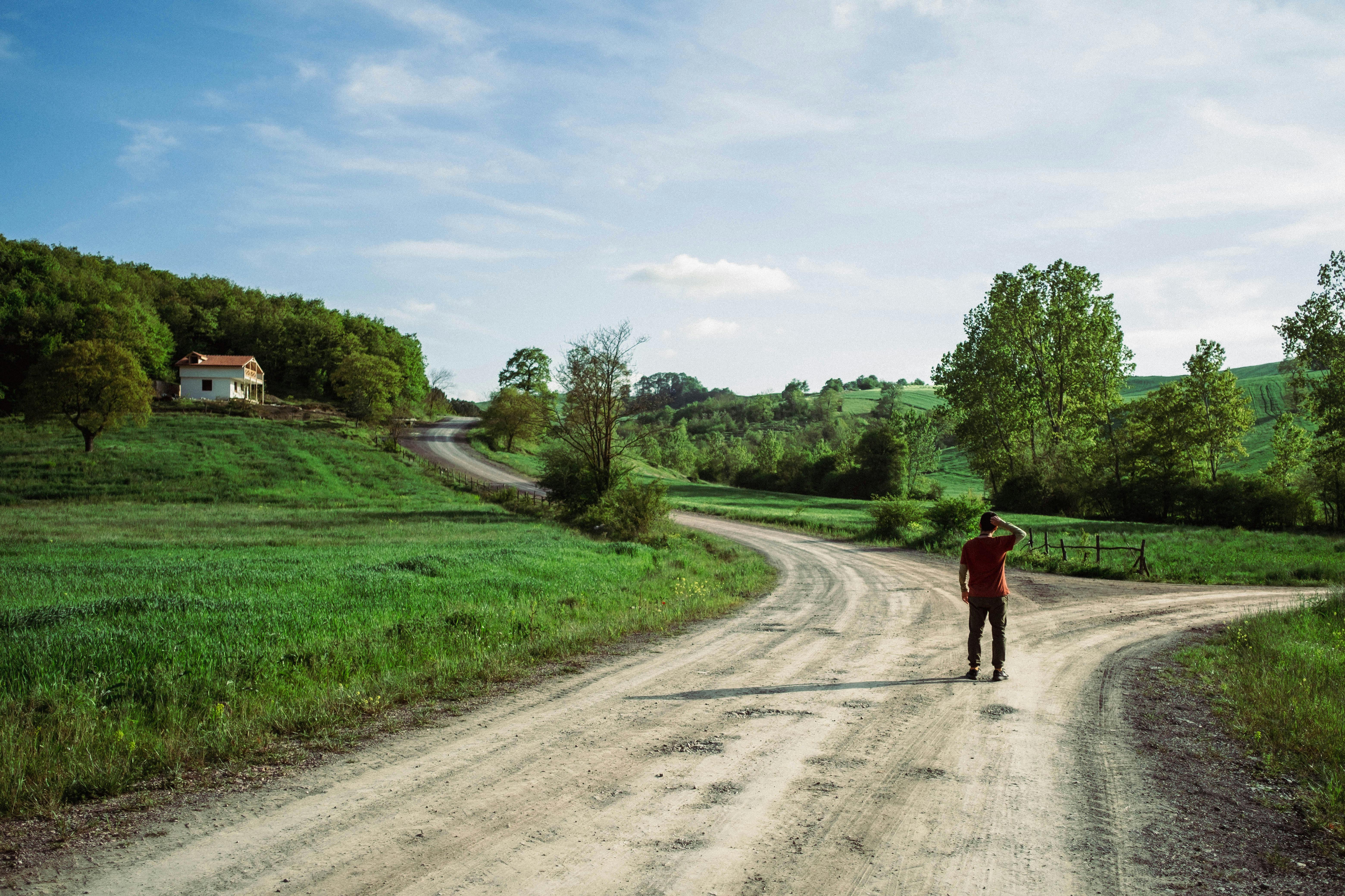 Man standing on a dirt road in the serene İzmit countryside.
